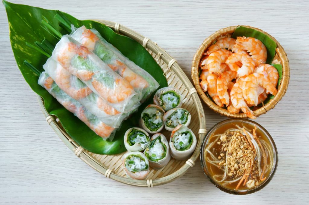 Goi Cuon, sauce and shrimps on a table