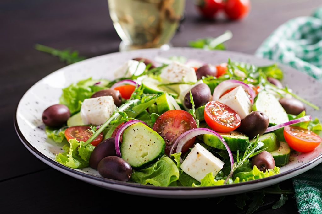 A dish full of fresh ingredients, vegetables and fresh cheese