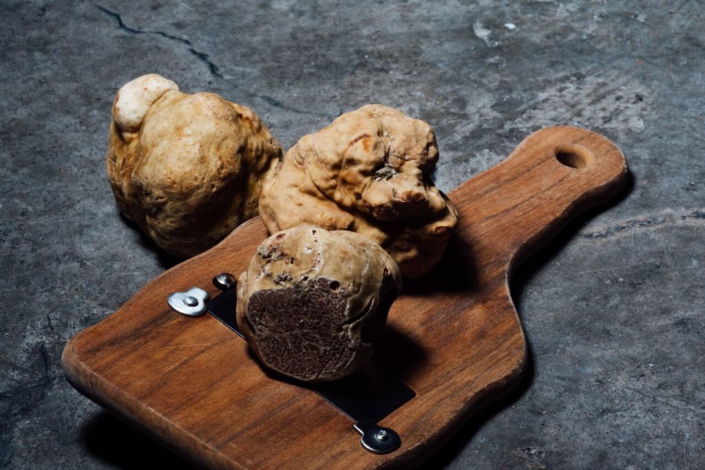 Truffles and their cutter on a table